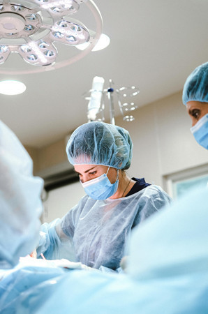 Surgical team performing a procedure under operating lights at Riverside Cardiology Associates