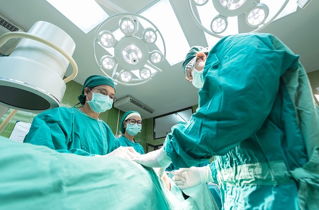 Surgical team in green scrubs performing heart surgery in an operating room at Riverside Cardiology Associates